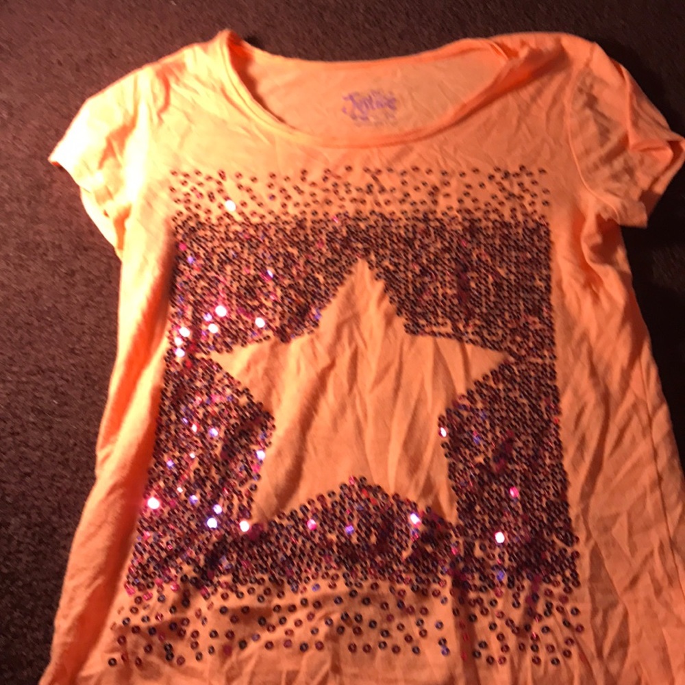 It is an orange tshirt with a pink and purple star